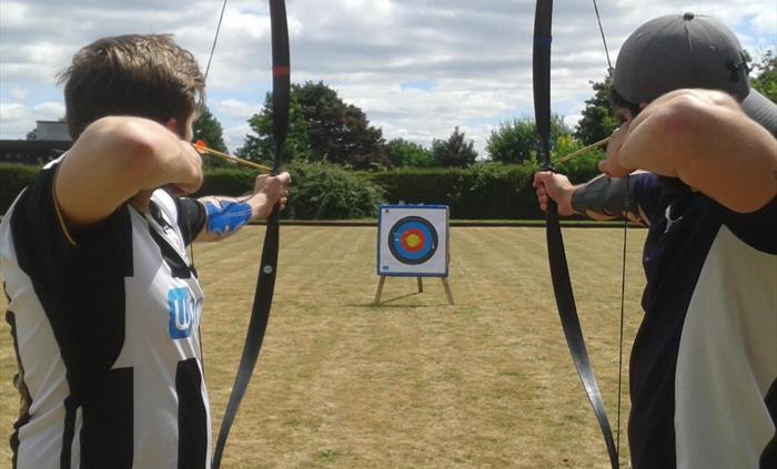 Two people preparing to shoot arrows
